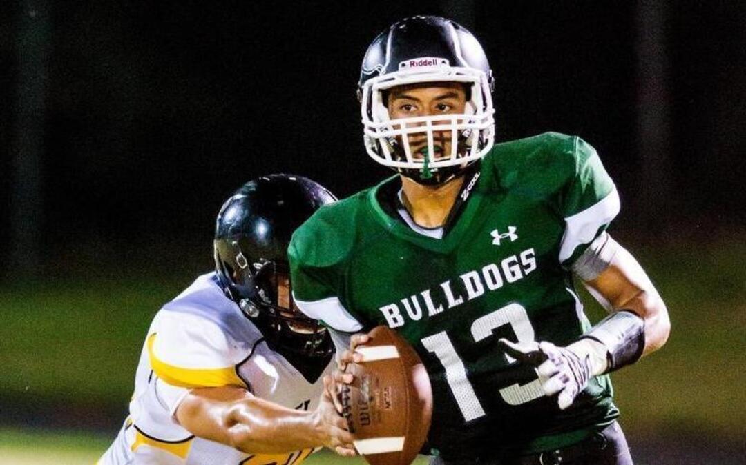 
Southeast Raleigh senior Dylan Parham (13) breaks a tackle from Chapel Hill senior George McBurney (60) during a football game at Southeast High School.
