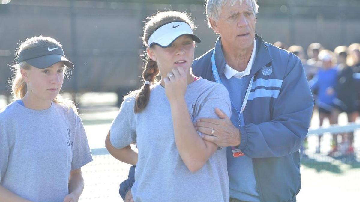 John Frye, right, head coach of Union Pines consoles his players at the end of the women dual team tennis games between the Union Pines Vikings and the Marvin Ridge Mavericks that took place at the Burlington Tennis Center in Burlington, N.C. on Saturday, November 12, 2016.
