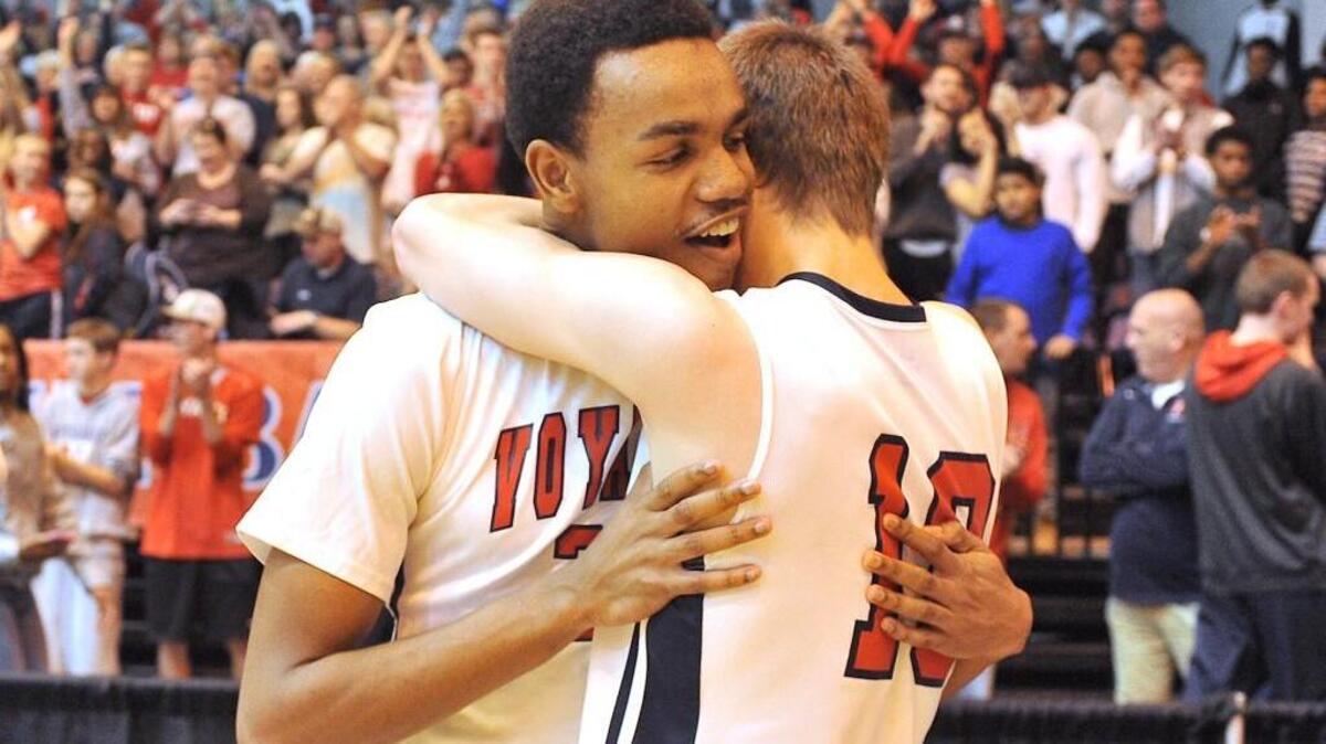 Voyager Acacdemy's China Jones (22) embraces teammate Matt Miketa (10) after their victory over South Creek in the 1A Eastern Boys Final. The Voyager Academy Vikings took on the South Creek Cougars in the NCHSAA Championship 1A East Boys Final in Crown Arena in Fayetteville, N.C. on March 5, 2016. Voyager Academy wins 71-50.