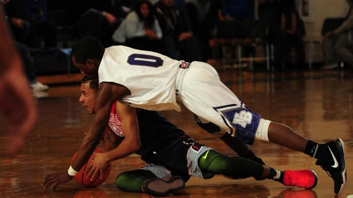 Broughton’s D.J. Thomas, top, dives for a loose ball after knocking it away from Downey Christian’s Julian Newman, bottom.