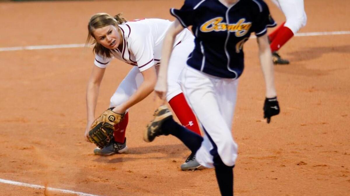 Middle Creek first baseman Claudia Penny scoops up a bunt and tries to throw out D. H. Conley's Morgan Shirley at first during D. H. Conley's softball game at Middle Creek on Tuesday, March 1, 2016. D. H. Conley won the game 5-4.