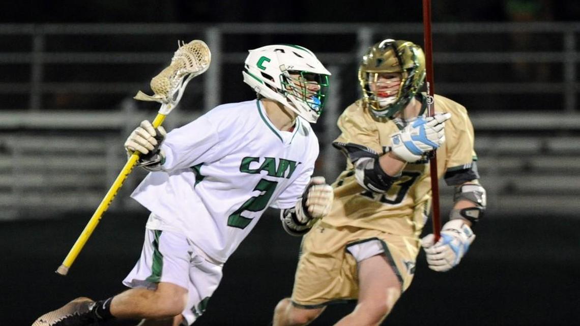Pinecrest's Ryan Voltz (right) challenges Cary's Hunter Hanrick (2) during the boys lacrosse game, which was played in Cary on Wednesday, March 2, 2016.
