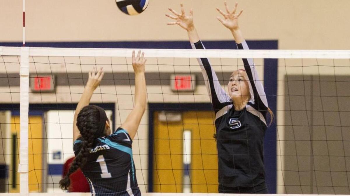 
West Johnston’s Tatianna Thompson (1) taps the ball over the net while Comet's Brianna Davis (5) challenges her during the High School Volleyball game between the West Johnston Wildcats and the Clayton Comets in Clayton, N.C. on Thursday, October 8, 2015. West Johnston won 3-0.
