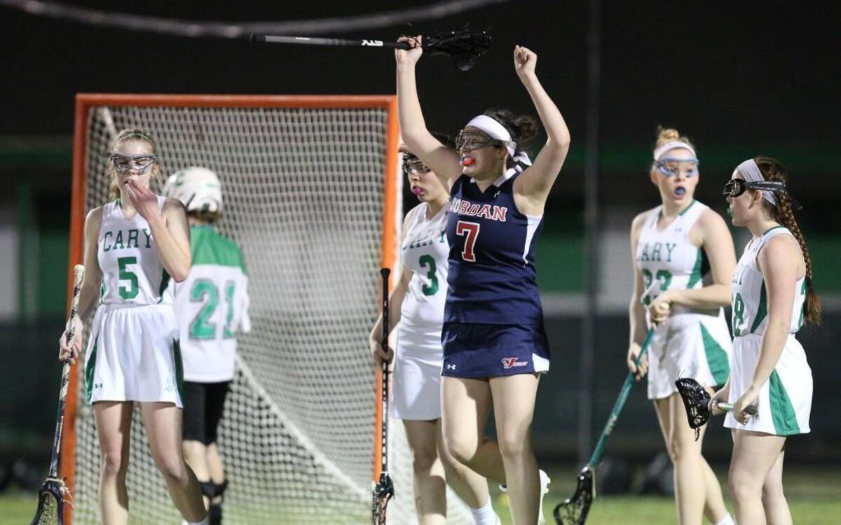 Jordan's Lindy Charles (7) gets the game winning point and starts to celebrate during the Jordan Falcons high school Lacrosse game with the Cary Imps high school, March 8, 2017, in Raleigh, N.C. Jordan won 11-10.