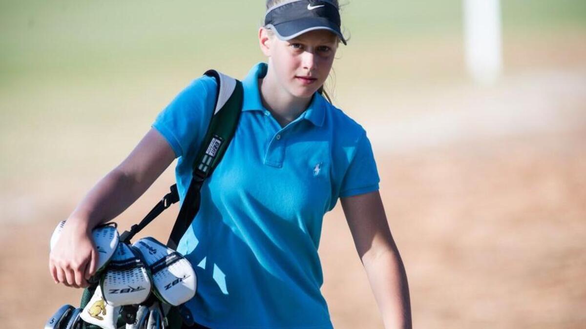 
Riley Smyth, from Cardinal Gibbons picks up her clubs after finishing two days of play at the 2014 NCHSAA Women's 3A State Golf Championship was held on Tuesday, October 28, 2014 in Southern Pines at Longleaf Golf and Country Club.
