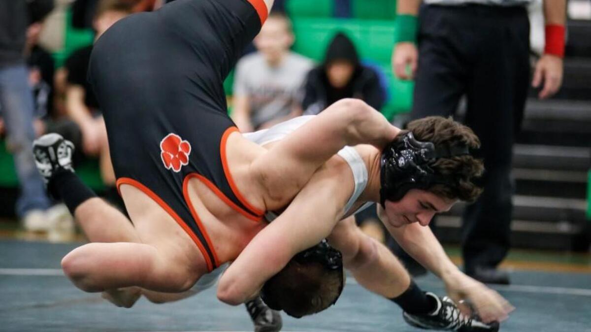Cary's Troy Madden throws Fuquay's Austin James before winning their 160-pound match by pin during Fuquay-Varina's wrestling match at Cary on Wednesday, January 27, 2016. Cary won the match 53-16.