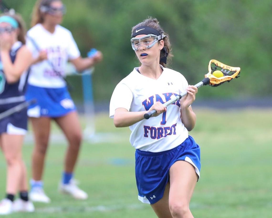 Wake Forest's Grace Whitcomb (7) looks to pass the ball into the crease area. Coverage from the girls lacrosse game between the Wake Forest Cougars and the Leesville Road Pride played in Wake Forest, N.C. on Wednesday, April 19, 2017. Leesville Road defeated Wake Forest 7-4.