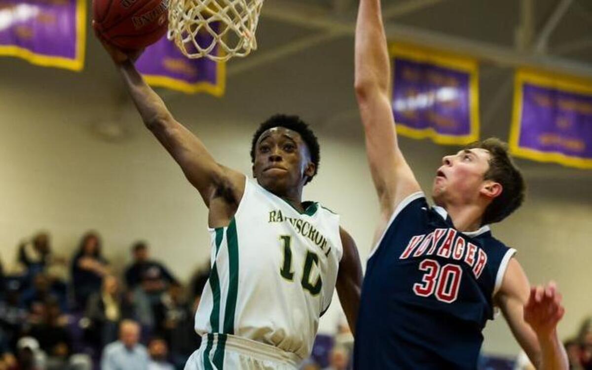 Ravenscroft's Michael Okauru (10) shoots over Voyager's Jay Huff (30) during a basketball game at the HighSchoolOT.com Holiday basketball tournament at Broughton High School in Raleigh on Monday, December 28, 2015. The Ravenscroft Ravens won 91-56.