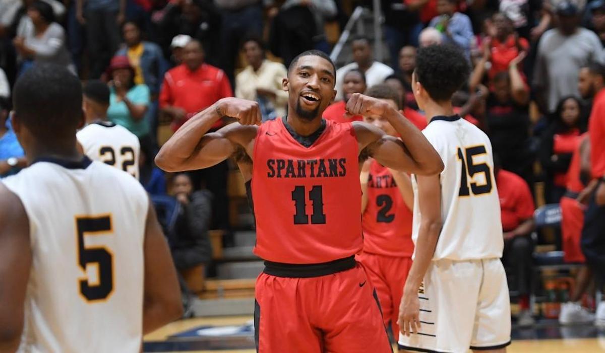 Jomaru Brown (11) of Southern Durham celebrates after scoring the winning basket for the Spartans. The Southern Durham Spartans and the Northern Durham Knights played in the Big Eight 3A Conference boys basketball tournament championship on Feb. 16, 2018.