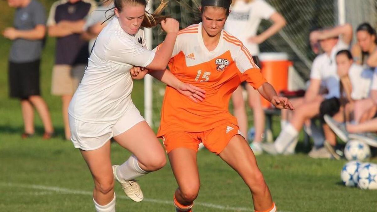 Cary Christian's Hannah Waters (12) keeps Grace Christian's Micah King (15) from the ball during the Grace Christian Raleigh high school soccer game with the Cary Christian high school on April 20, 2017. Grace Christian Raleigh won the game 2-0.