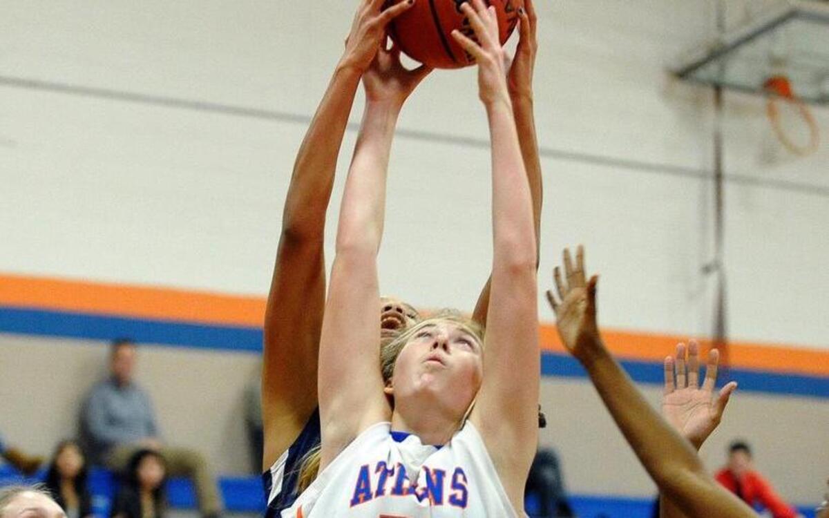 Athens Drive's Robin Gallagher (25) and Lee County's Tashari Wells-Tucker (back) battle for a rebound. The Lee County Yellow Jackets girls basketball team played the Athens Drive Jaguars in Raleigh on Thursday, November 20, 2014. Athens Drive won 68-25.