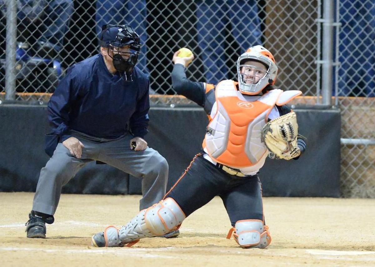 Mia Davidson, right, of Orange throws to the first base. The Cardinal Gibbons Crusaders played the Orange Panthers in a softball game that took place in Hillsborough, N.C. on Friday, March 10 2017. Orange won 17-2.