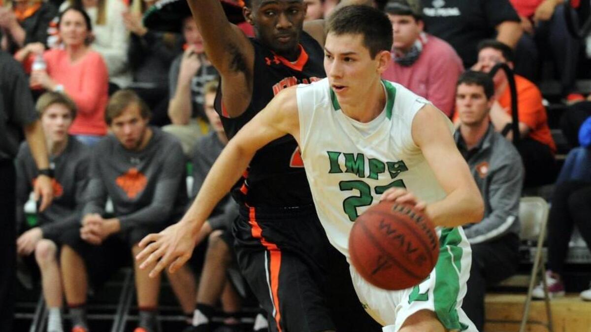 Cary's Cory Gensler (22) drives past New Hanover's Accheaus Fields during the fourth round of the NCHSAA 4A boys basketball playoffs, which was played in Cary on Tuesday, March 1, 2016. Cary won 58-49 in overtime.