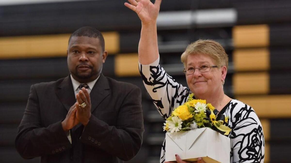Chapel Hill High coach Sherry Norris waves to the crowd after being recognized for her coaching career after the game against Cedar Ridge on Friday, January 27, 2017. The game was the final regular season home game of Norris's career. Special to The Herald-Sun | John Joyner
