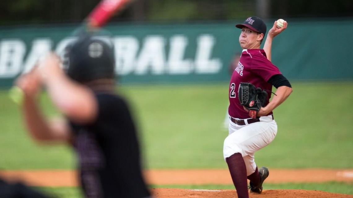 Green Hope pitcher Mitch Spence sends a pitch to Holly Springs' Cole Hoops, left, during a high school baseball game in Cary, N.C. on Friday, April 8, 2016.