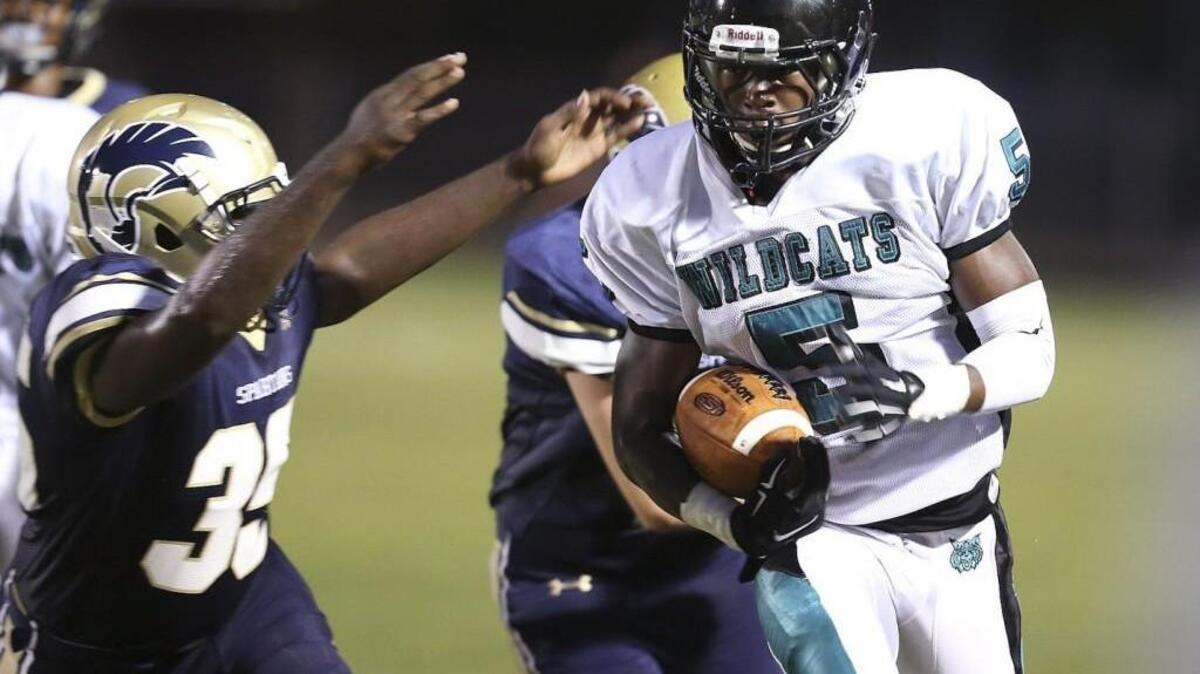 
Smithfield-Selma’s Tyquan Dublin (35) dives for West Johnston’s Deandre Blevins (5) along the sidelines during the Wildcats’ victory Friday night.
