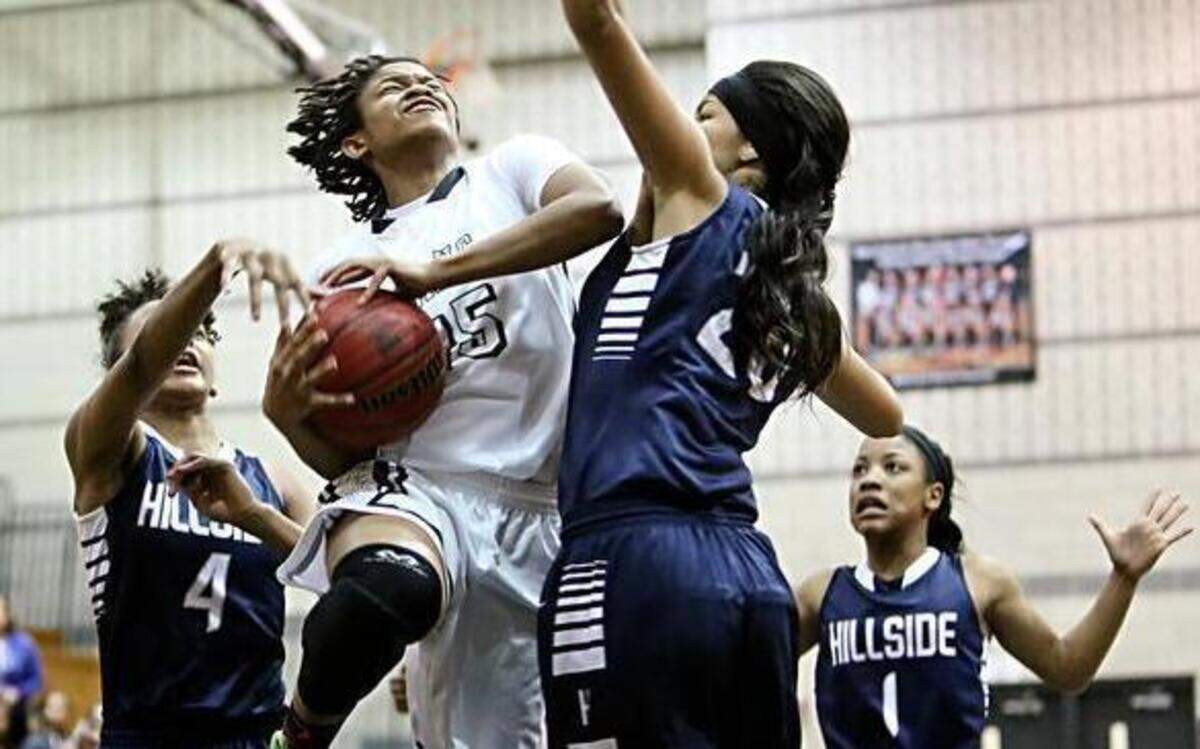 
Southeast's Jada McMillian (15) drives around Durham Hillside's Amanda Lawrence (20) during the Girls 4A Basketball Third Round NCHSAA Playoffs between Southeast Raleigh High School and Durham Hillside High School, March 3, 2015 in Raleigh, N.C. Southeast wins 56-52.
