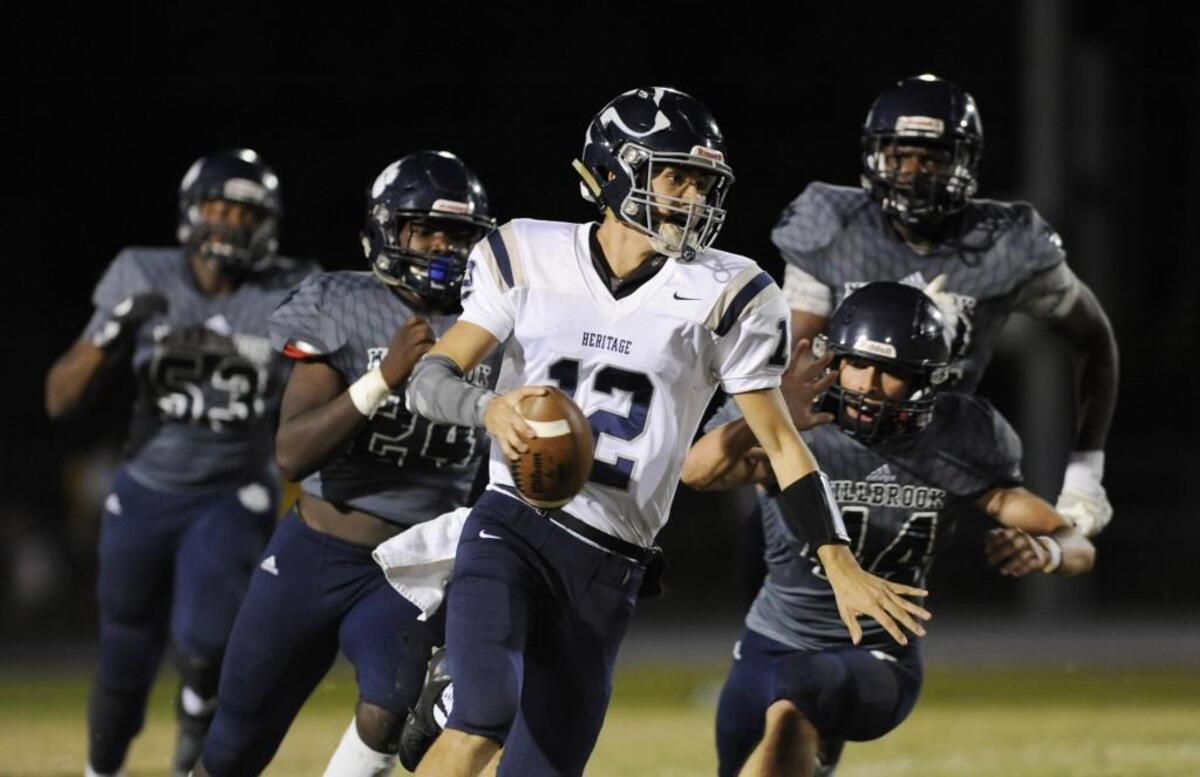 Heritage quarterback Gunnar Holmberg (12) carries the ball for a touchdown against Millbrook in Raleigh, N.C. on Friday, October 21, 2016.