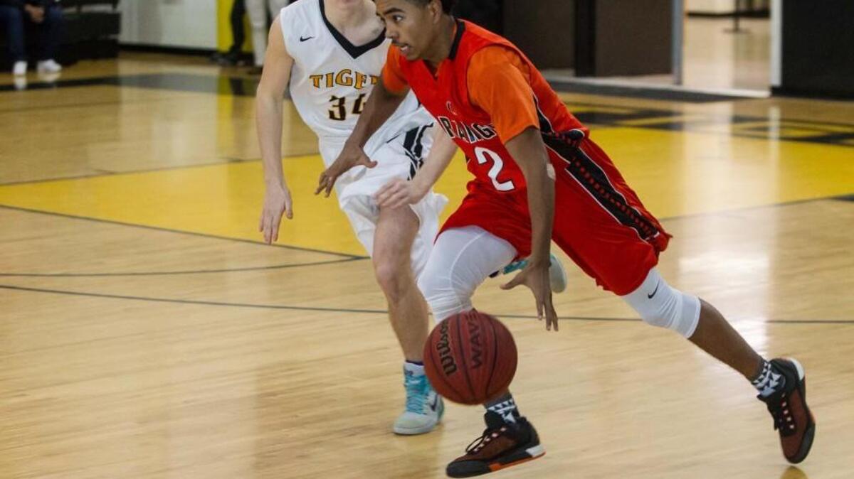 Orange’s Reggie Bradsher drives past Chapel Hill’s Max Conolly. The Orange Panthers and Chapel Hill Tigers played a boys game in Chapel Hill, N.C. on Friday, January 8, 2016. Orange won 77-69.