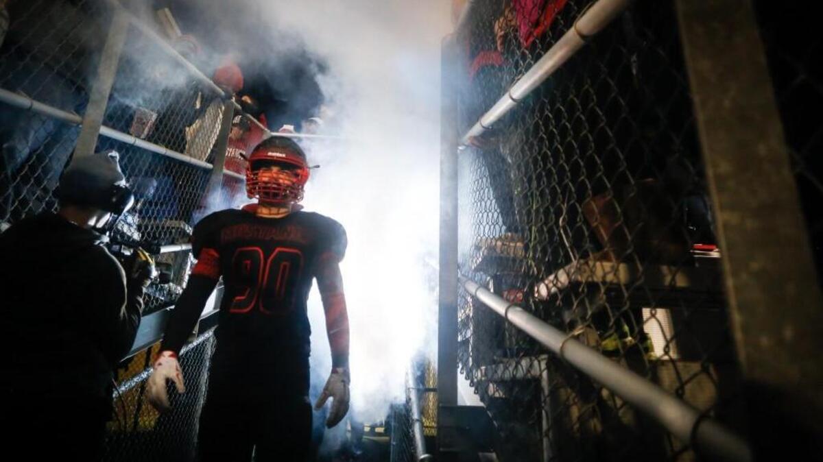 Middle Creek’s George Maya III gets ready to take the field before a playoff game against Millbrook on Friday, November 20, 2015.