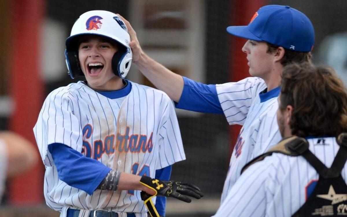Colby Wilkerson, left, of Kerr-Vance Academy celebrates along his teammates Daniel Wilkerson, center, and Lane Humphries, right after scoring in the 6th inning during their 5-2 victory over the J.F. Webb Warriors in Oxford on Tuesday, March 29, 2016.