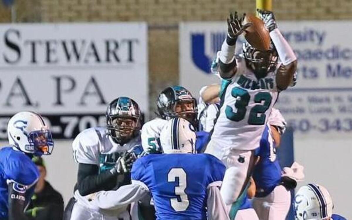 
West Johnston High’s Jowann Holder (32) breaks through Clayton defenders to block kicker Daniel Alioto’s (3) extra point attempt just before the half. The Wildcats of West Johnston High School defeated the Comets of Clayton High School 27-25 played in Clayton, N.C. on Friday, October 31, 2014.
