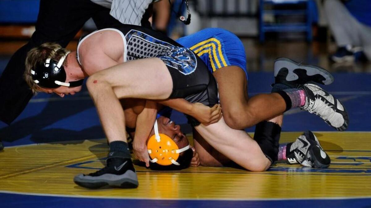 Clayton’s Christian Prescott tries to keep his advantage on Garner’s Cushan Jones in their 113-pound match of Wednesday’s Greater Neuse River 4A Conference dual quad.