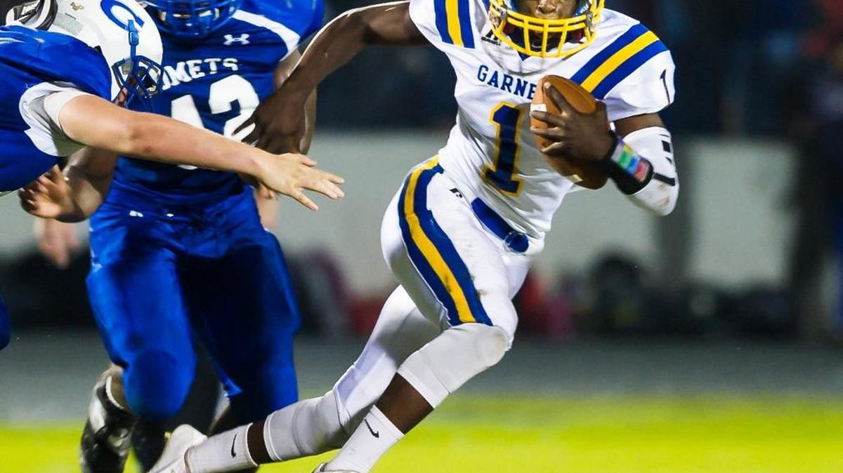
Garner’s Braxton Brokenborough (1) breaks a tackle from Clayton's Kyron Bennett (42) during a football game on Friday, October 09, 2015 in Clayton, N.C. Garner Trojans won 37-14.
