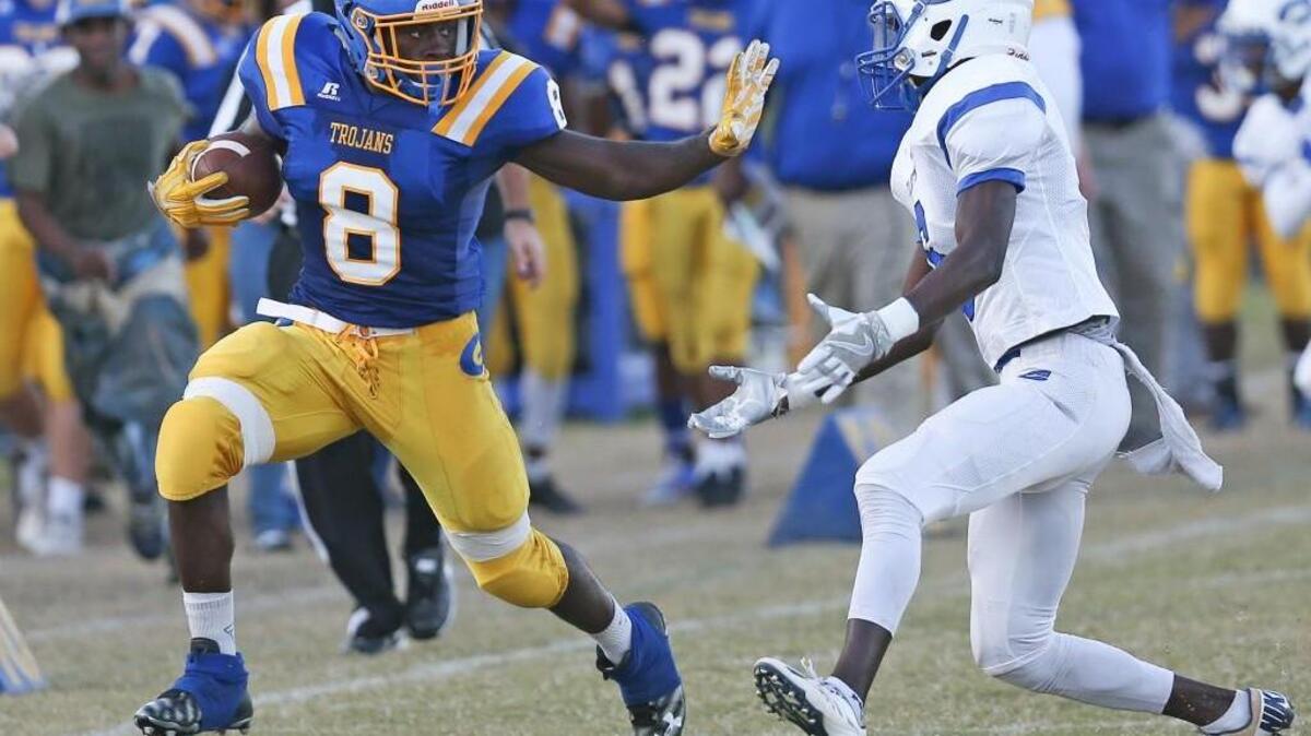 Garner's Collin Eaddy (8) tries to ward off Clayton's Romeo Stancil (6) as he makes a big gain around end. Coverage from the prep football game between the Clayton Comets and the Garner Trojans played in Garner, N.C. on Thursday, October 10, 2016. Garner defeated Clayton 50-0.