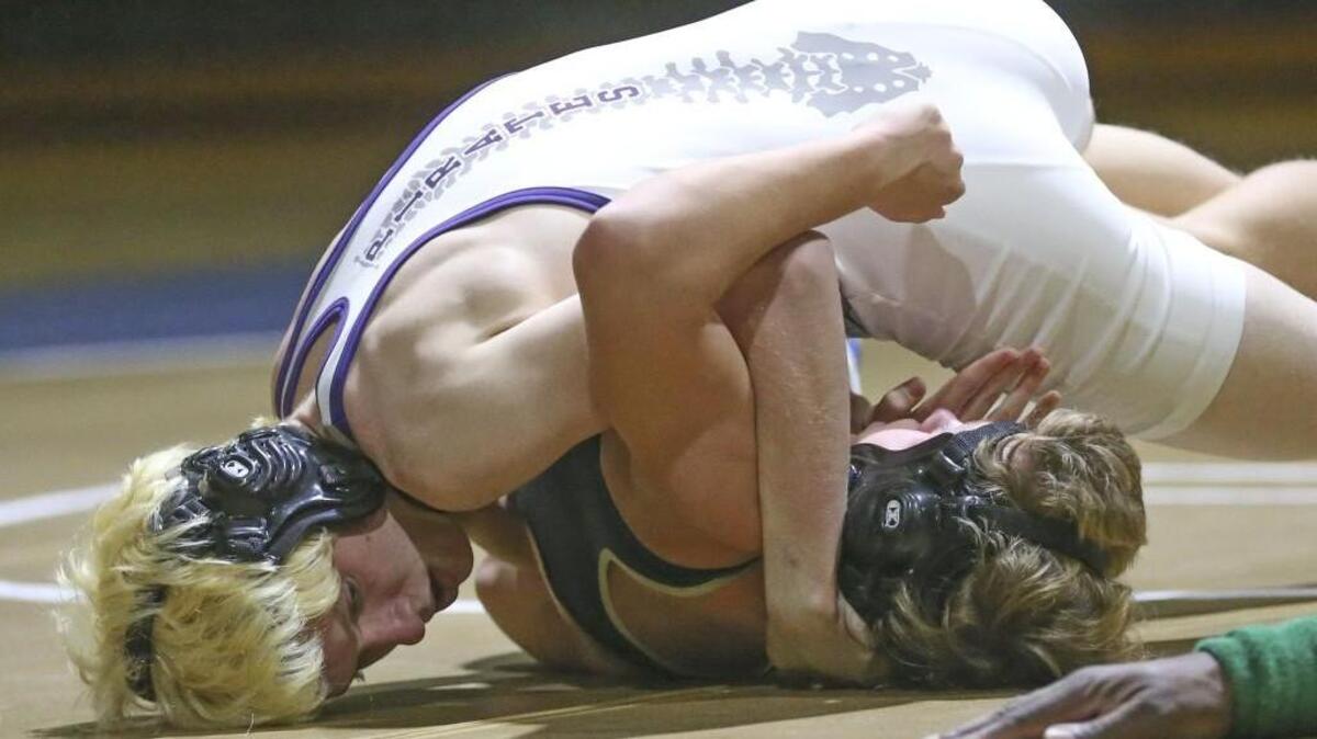 Corinth Holders' Issac Cook (top) rolls Smithfield-Selma's Steven Taylor for the near-pin and goes on for the win in the 120 pound weight class. Coverage from the high school wrestling match between the Spartans of Smithfield-Selma High School and the Pirates of Corinth Holders High held in Smithfield, N.C. on Thursday, January 21, 2016. Corinth Holders defeated Smithfield-Selma 68-12.