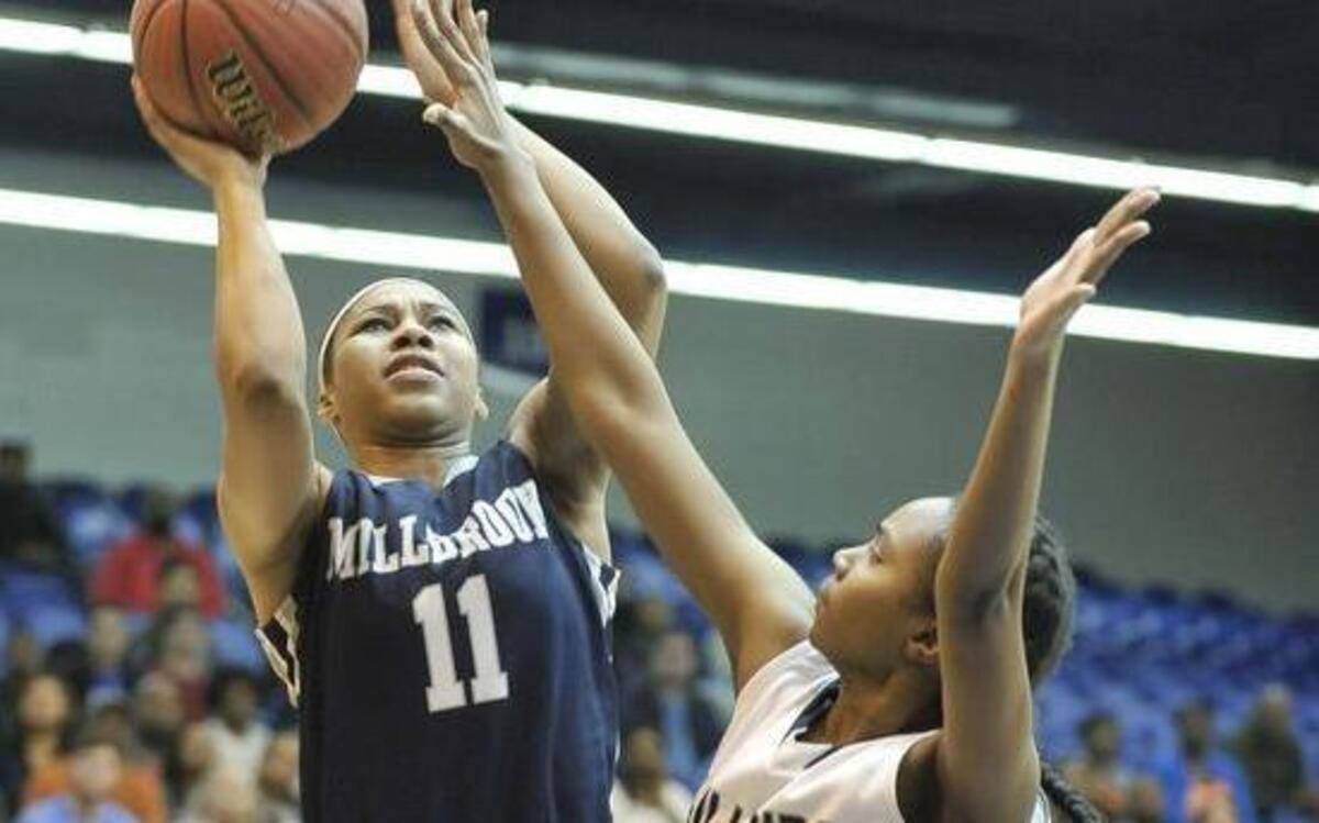 Millbrook's Dazia Powell (11) shoots over Hillside's Jada Morgan (21) during the of the NCHSAA 4A East finals girls’ basketball game, Millbrook against Hillside. Millbrook wins 58-51. Saturday, March 5, 2016. Crown Arena, Fayetteville, N.C.