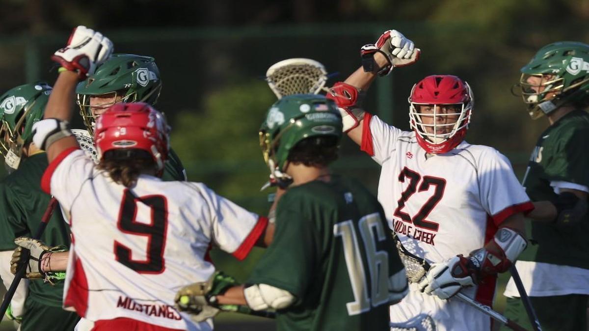 Middle Creek's Owen Caputo (22) ties the game 1-1 just a minute after the Cardinal Gibbons score. Coverage from Eastern Regionals of the 4A NCHSAA Boys Lacrosse playoffs between the Middle Creek Mustangs and Cardinal Gibbons Crusaders played in Raleigh, N.C. on Tuesday, May 16, 2017. Middle Creek defeats Cardinal Gibbons 14-8 to win the Eastern finals and heads to the state championship.