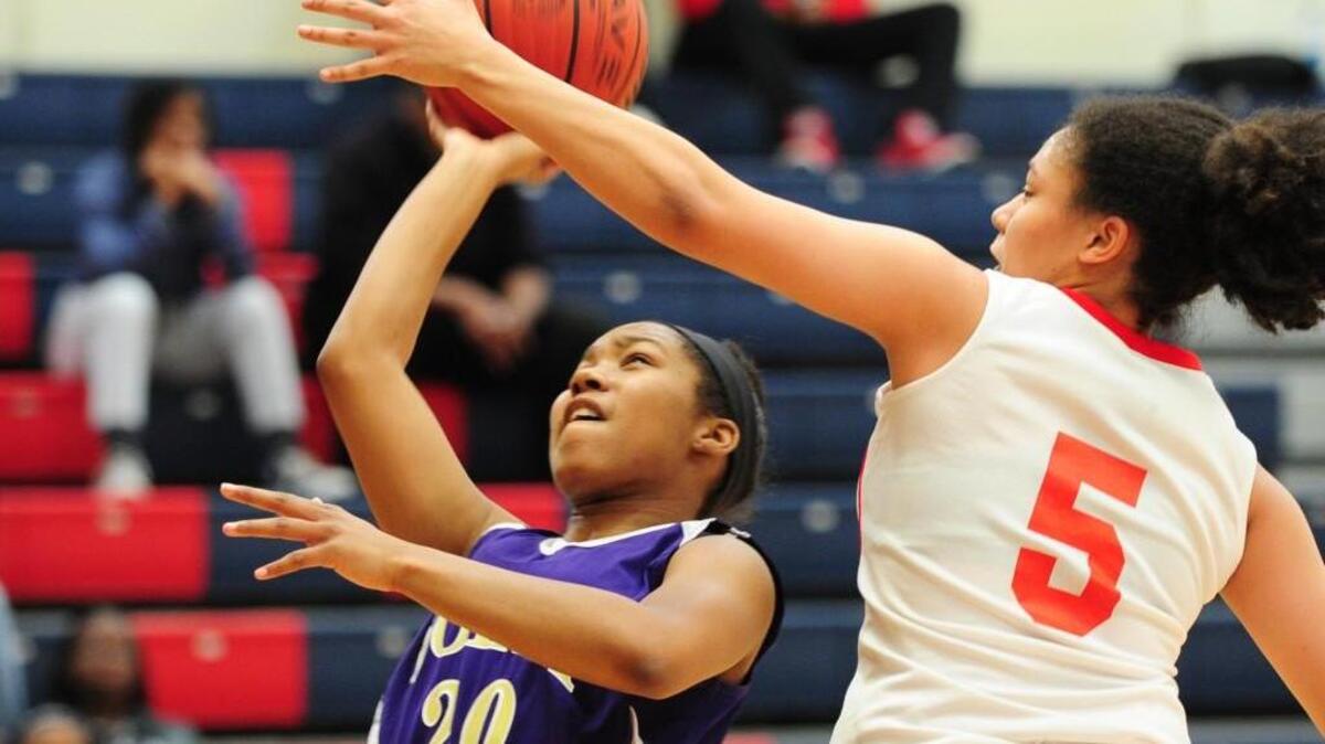 Holly Springs’ Brianna Tate (20) shoots past Southern's Marissa Mackins (5) during the girls basketball game, which was played on Monday, January 18, 2016 in Durham. Holly Springs won 66-58.
