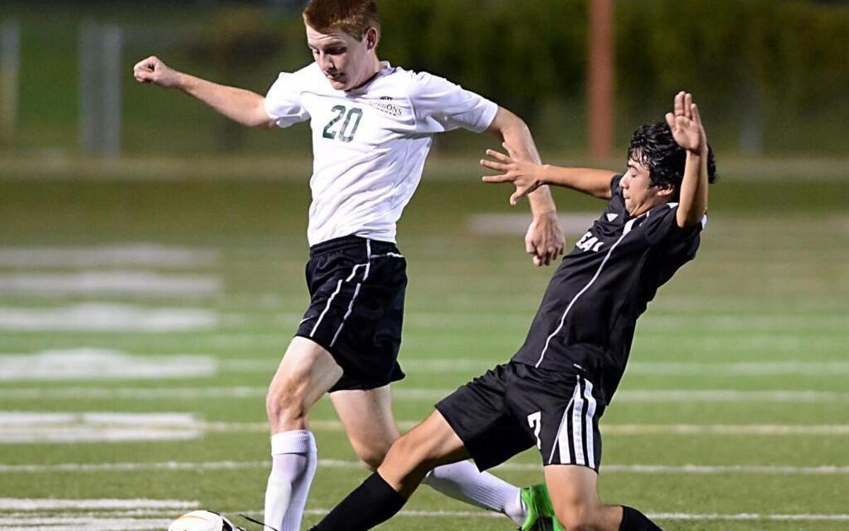 
Cardinal Gibbons’ Nicholas Vorobiov (20) East Chapel Hill's Anthony Rodriguez (7) go for the ball during their match in Raleigh, N.C. East Chapel Hill Wildcats went onto win in extra time over the Cardinal Gibbons Crusaders on Wednesday, October 7, 2015.
