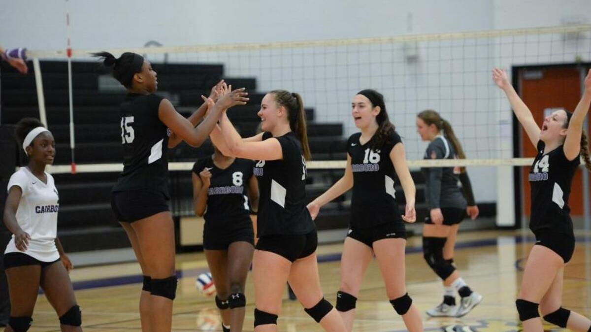 Carrboro celebrate the win at the end of the game. From left to right, Destinee Dorsey, Destiny Cox, Christine Alcox, Sarah Montross, Kirby Thornton and Grace Maggiore. The Carrboro Jaguars played the Bartlett Yancey Buccaneers in a volleyball match that took place in Carrboro, N.C. on Wednesday, October 19, 2016. Carrboro won 3-0.