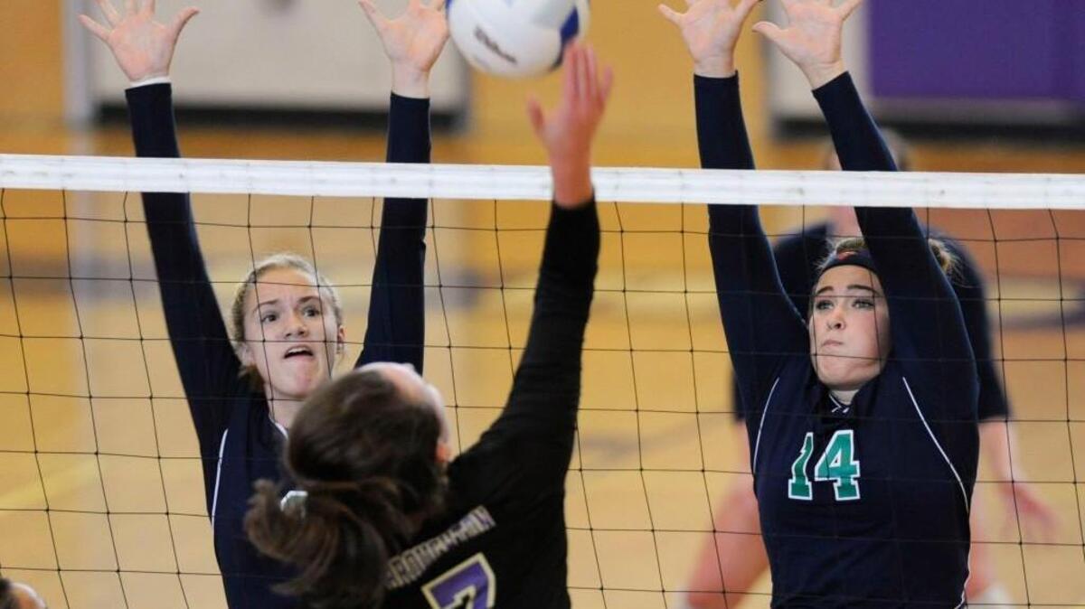 
Leesville Road's Daniela McDonald (8) and Jenna Lyon (14) try to block a hit by Broughton's Kati Smith (7) in Raleigh, N.C. on Thursday, September 17, 2015. Broughton won the match 3-0.
