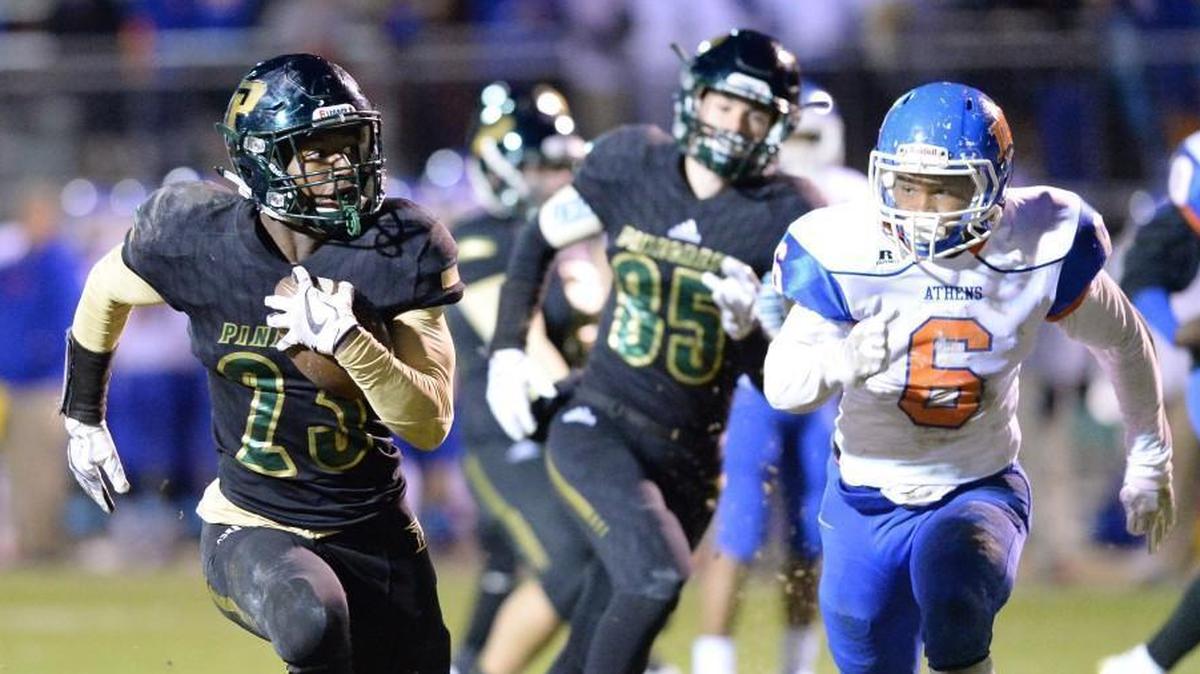 Zaythan Hill (23) of Pinecrest avoids the pursuit of Giovanni Heyward (6) of Athens Drive to score a touchdown for the Patriots. The Athens Drive Jaguars visited the Pinecrest Patriots in a high school football game on Nov. 10, 2017. Pinecrest won 50-19.