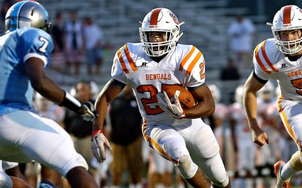 
Fuquay-Varina's Josh Arrington (27) cuts inside of Cleveland's Delancey Starkes (7) to put the Bengals up 6-0 on the opening drive of the game. Fuquay leads at the half 28-22.
