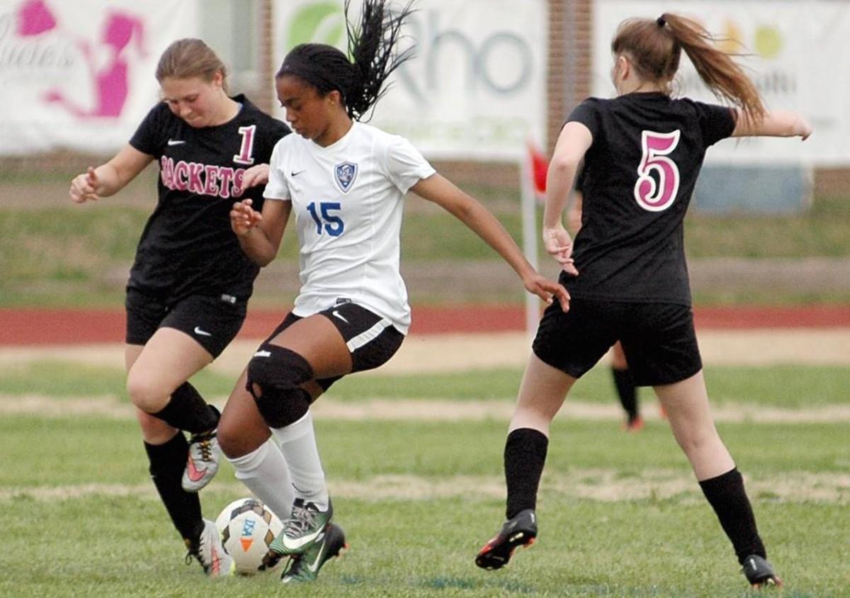 Durham School of the Arts' Nona Borden (15) fights for the ball with Karrington Blackmon (1) and Taylor Epps of Roanoke Rapids in a girls' soccer match on Wednesday, March 29, 2017 at DSA.