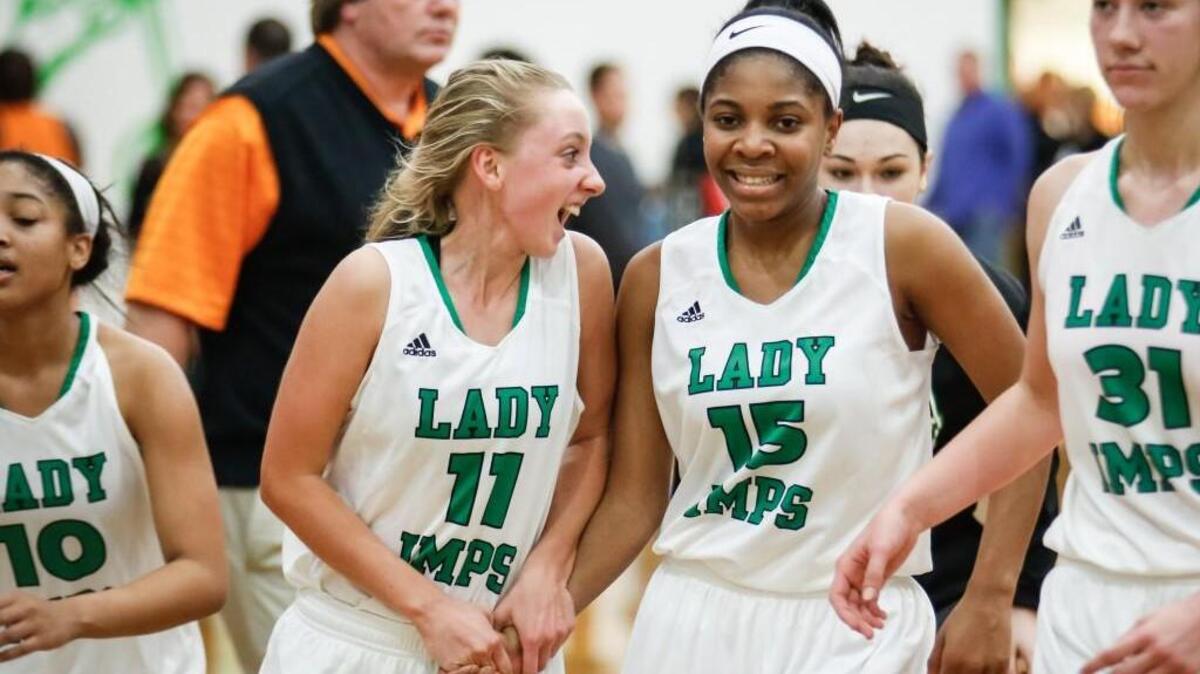 Cary's Megan Cannady (11) celebrates their victory with teammate Lauren Fisher (15) following Fuquay-Varina's girls basketball game at Cary on Friday, January 8, 2016. Cary won the game 40-26.