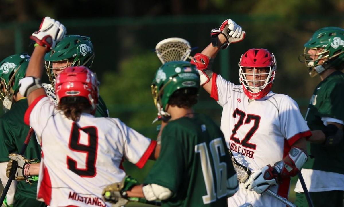 Middle Creek's Owen Caputo (22) ties the game 1-1 just a minute after the Cardinal Gibbons score. Coverage from Eastern Regionals of the 4A NCHSAA Boys Lacrosse playoffs between the Middle Creek Mustangs and Cardinal Gibbons Crusaders played in Raleigh, N.C. on Tuesday, May 16, 2017. Middle Creek defeats Cardinal Gibbons 14-8 to win the Eastern finals and heads to the state championship.