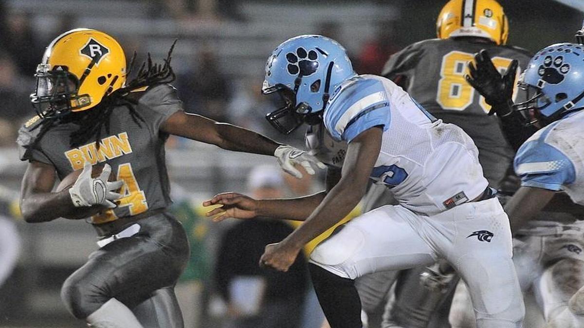 Bunn's Tevin Perry (24) sprints for yardage ahead of East Duplin's Zack Robinson(25) and Dockem Woodson (8). The East Duplin Wildcats took on the Bunn Panthers in the NCHSAA 2AA third round playoff game in Bunn, N.C. on Friday, November 27, 2015. Bunn wins 36-29.
