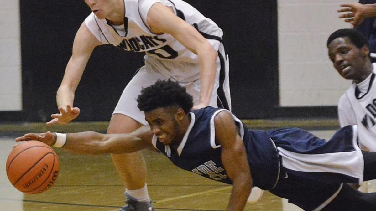Hillside's Derrick Wiley and East Chapel Hill's Justin Tucker battle for a loose ball at East Chapel Hill High School.