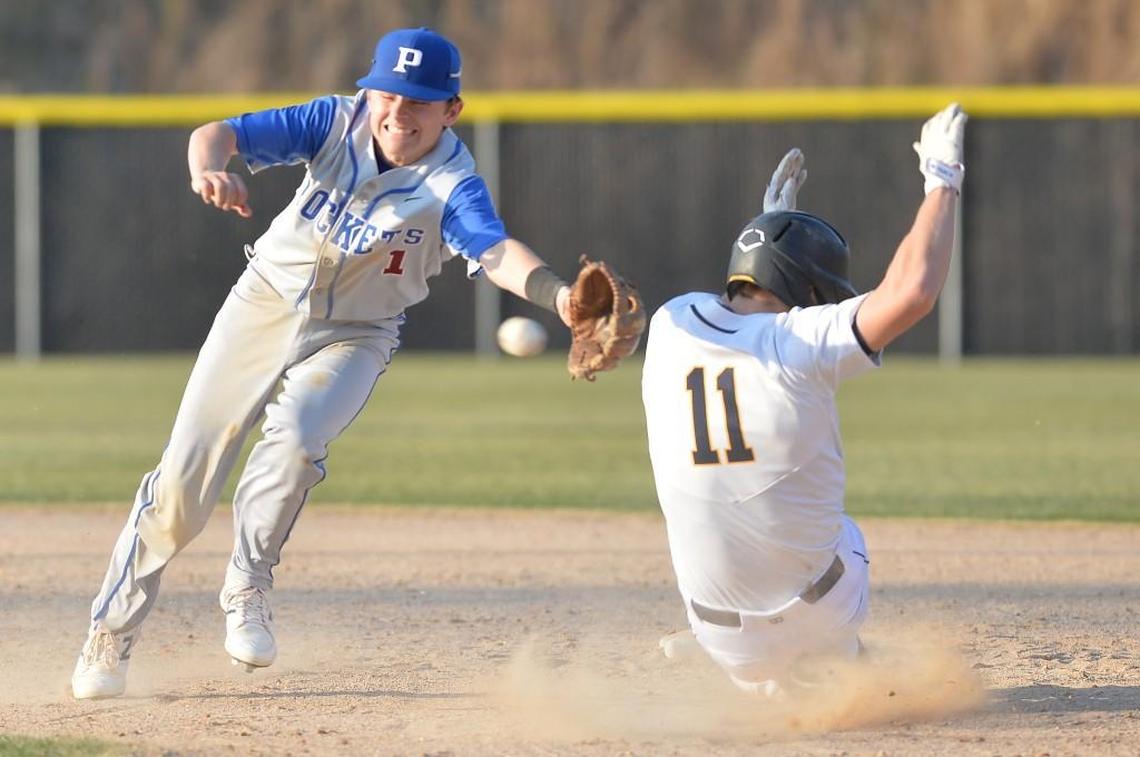 Spencer Smith (11) of Northern slides to safety at the second base against Casey Nichols (1) of Person off a hit from his teammate Luke Fenlon during the 6th inning. The Northern Durham Knights played the Person Rockets in a baseball game that took place in Durham, N.C. on Tuesday, March 21 2017. Northern Durham won 3-2.