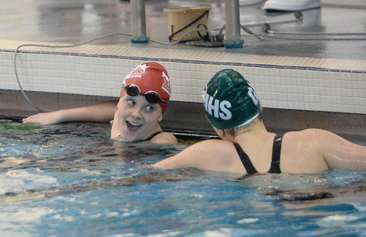 Julia Poole, left, of Middle Creek and Kate Moore, right, of Green Hope congratulate each other at the end of the Women 200 Yard Individual Medley race during the NCHSAA 4A Swimming Championships that took place at the Triangle Aquatic Center in Cary, N.C. on Friday, February 10, 2017.