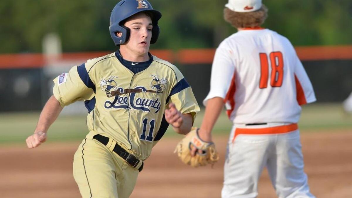 Evan Wells (11) of Lee County steps on to the third base against Hunter Tickle (18) of Southern Lee. The Southern Lee Cavaliers played the Lee County Yellow Jackets in a baseball game that took place in Sanford, N.C. on Friday, April 29, 2016.