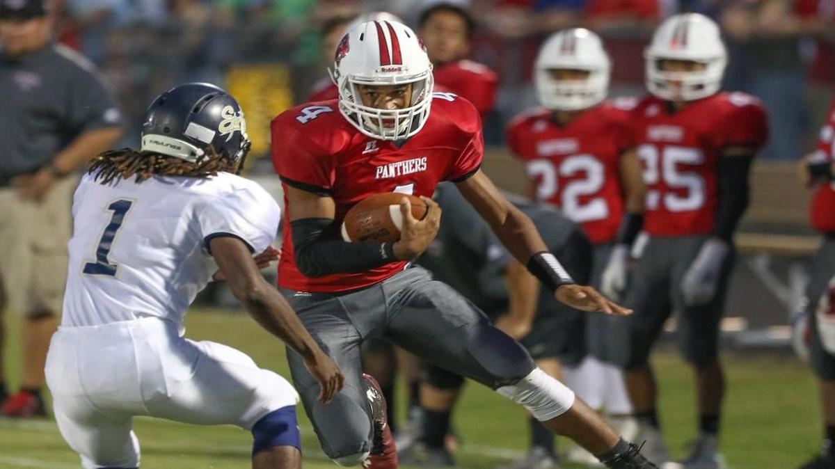 North Johnston's Trey Whitley (4) tries to cut inside of Smithfield-Selma's Ziggy Durogene (1) for additional yardage on the opening drive of the game. Coverage from the prep football game between the Smithfield-Selma Spartans and the North Johnston Panthers played in Kenly, N.C. on Friday, September 16, 2016. North Johnston defeated Smithfield-Selma 42-7.