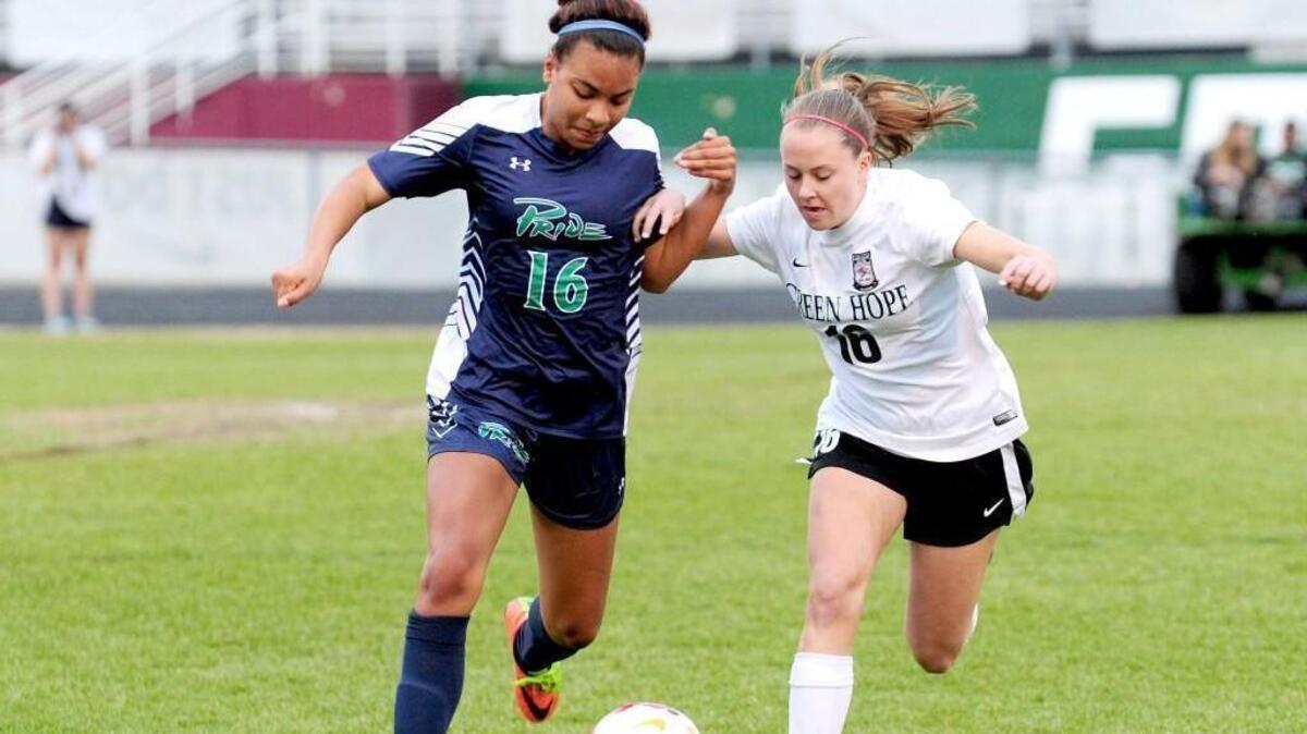 Green Hope's Tessa Hansen (right) and Leesville Road's Jordin Mosely battle for the ball. The Leesville Road Pride and the Green Hope Falcons played a soccer game in Cary on Monday, March 19, 2018.