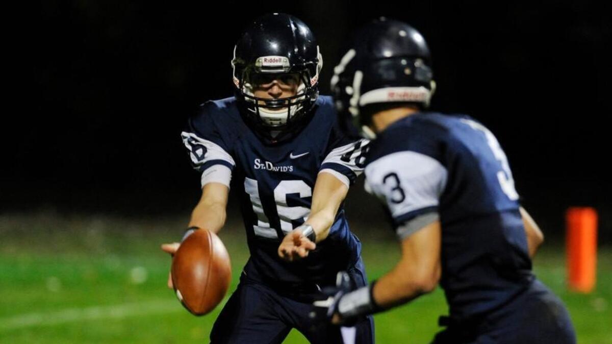 St. David’s quarterback Garrett Lewis, who threw 30 touchdown passes with only one interception last year, hands off to Trey Walker.