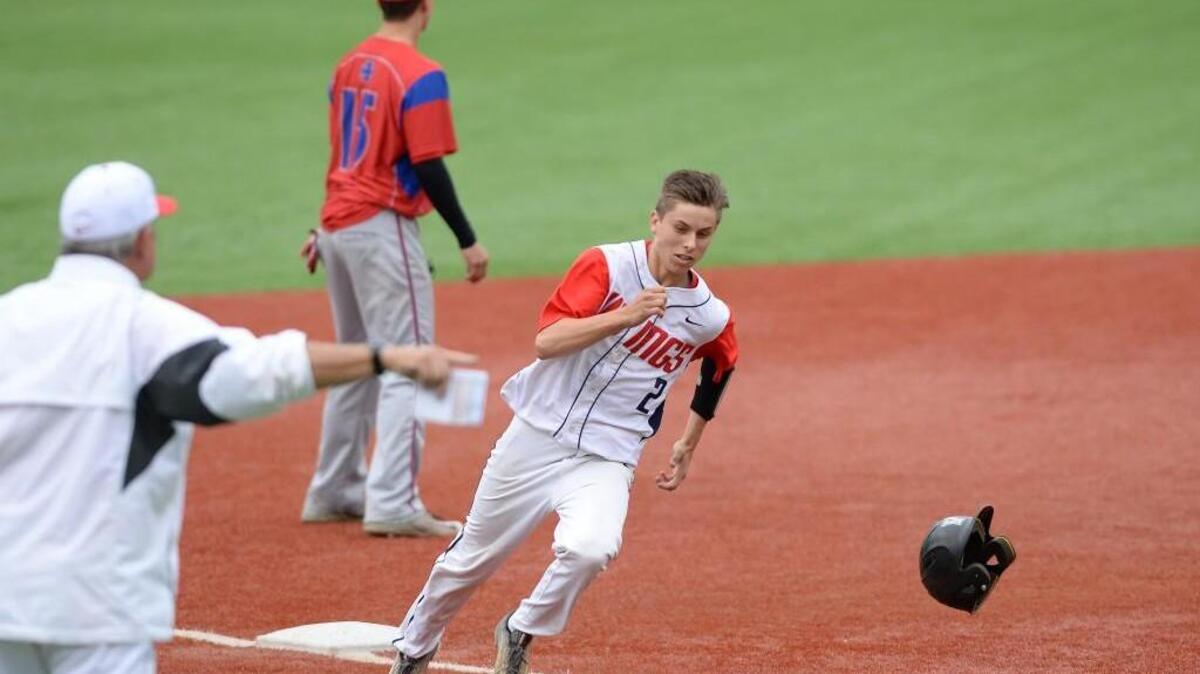 Chase Sykes (2) of Voyager Academy steps on to the third base under the directions from his coach Pete Shankle, left, to score for the Vikings. The Voyager Academy Vikings played the Gates County Red Barons in a baseball game that took place at the Duke University Coombs Field in Durham, N.C. on Friday, May 20, 2016. Voyager won 11-0.